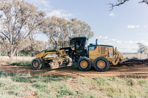 Grader ground levelling dirt road in Orange NSW