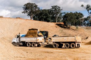Excavator loading dirt into truck in the Central West NSW